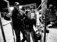 Derick Costa escorts his son Derick Costa Jr., 10, back after successfully riding his first bull at the final event in the New England Rodeo championship in Norton, MA.
